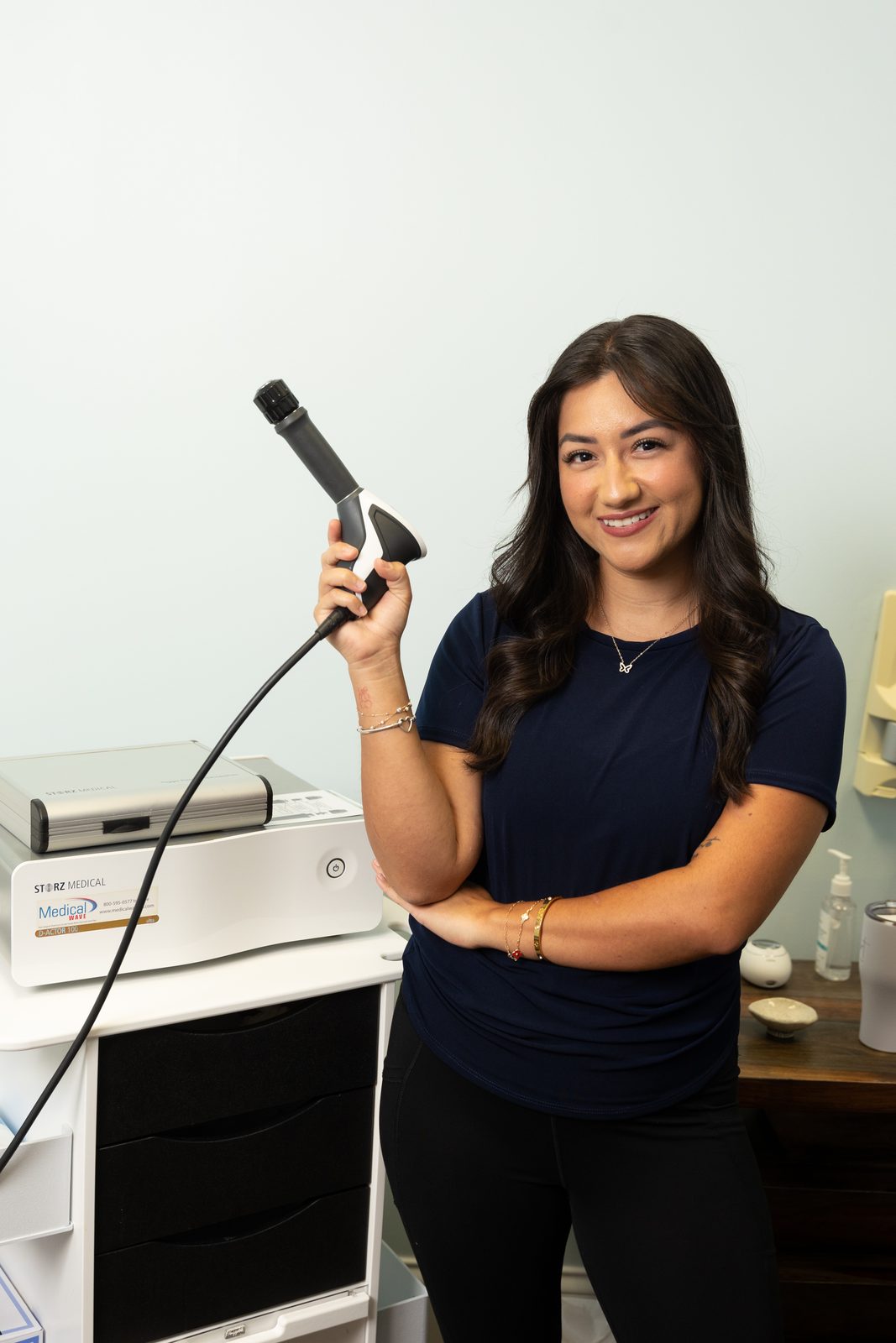 An EWL provider holding the FDA-cleared shockwave therapy handpiece
